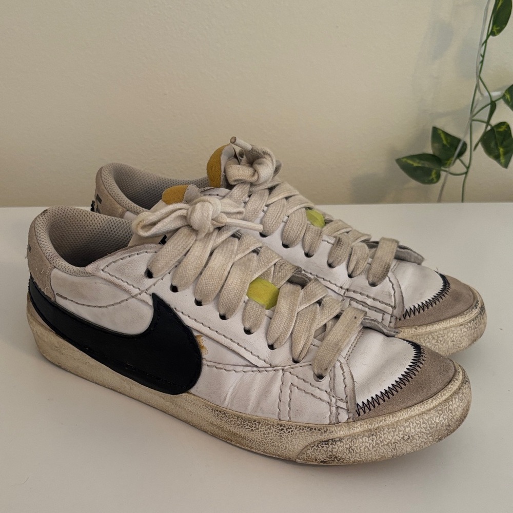 Nike White Sneakers with Black Swoosh and Yellow Tongue Accents
